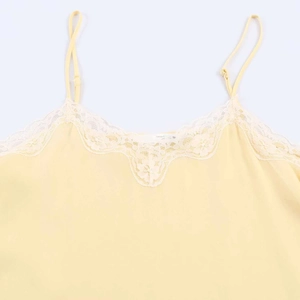 Pale yellow satin camisole with white lace trim and adjustable spaghetti straps
