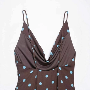 Deep brown spaghetti strap slip dress with sky blue polka dots and cowl neckline
