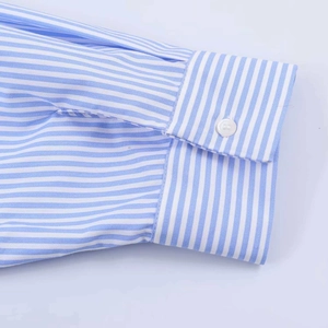 Macro detail of striped poplin shirt cuff with neat stitching and white button