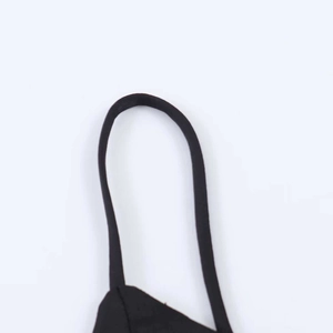 Detailed view of stitching and texture on an asymmetric black satin camisole strap