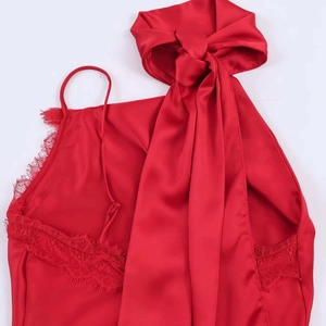 Close-up of red satin camisole top with eyelash lace trim and large bow detail