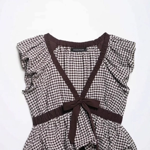 Women's balloon shape gingham top with bow tie and ruffled sleeves on white background