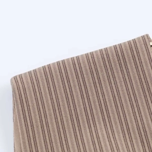 Macro view showing the textured fabric detail and brown striped pattern of the summer dress