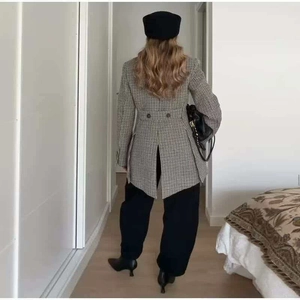 Women's chic black and white plaid blazer with asymmetric hem and waist buttons back view