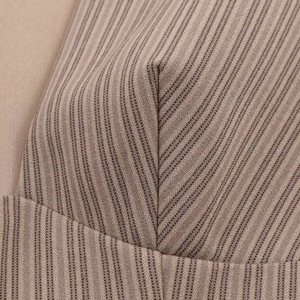Macro view of brown striped fabric seam showing high-quality woven texture and stitching detail