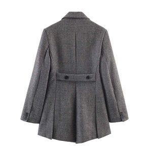 Detailed back view of a houndstooth blazer with waist strap and pleated hem detail
