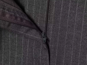 Détails de la fermeture éclair et de la texture à rayures du pantalon large gris foncé