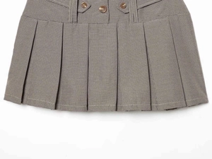 Detailed close-up of khaki houndstooth pleated mini skirt featuring three brown decorative buttons