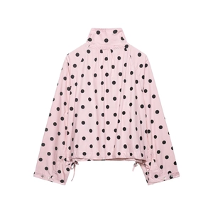 Detail of pink stand collar jacket with black polka dots and drawstring cuffs