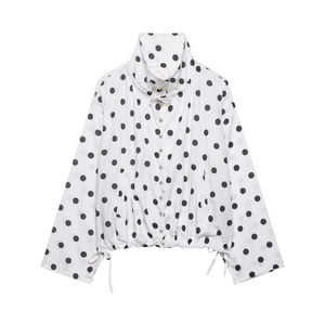 Detailed view of polka dot jacket featuring adjustable drawstring hem and white buttons
