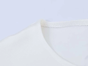 Close-up of neckline stitching and textured white chiffon fabric for a summer top