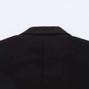 Detail of classic black blazer with elegant lapel collar and lace stitching on textured fabric