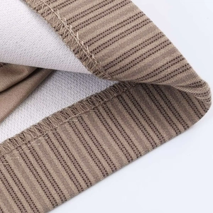 Close-up of overlock stitching and high-quality sewing on striped textile fabric