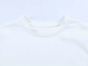 Close-up of the high-quality white crew neck and neat stitching on the lace-sleeve tee