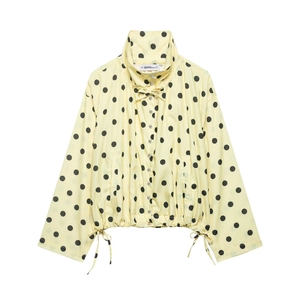 Detail of high collar long sleeve jacket with black polka dots and adjustable drawstring hem