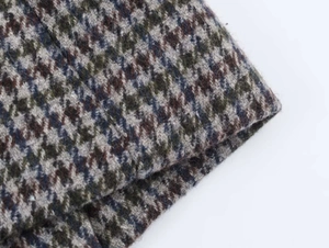 Macro shot of multicolored houndstooth wool fabric showing texture and weave details