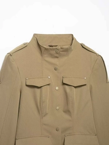 Detail of khaki utility jacket with stand collar, shoulder epaulets and metal snap buttons