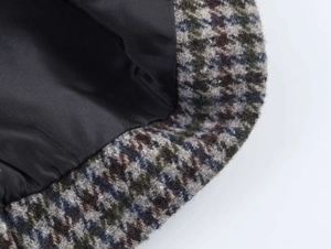 Macro shot of houndstooth wool fabric texture and black inner lining of the blazer
