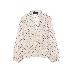 Detail of ruffled V-neck and brown polka dots on elegant long sleeve chiffon blouse