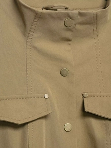 Close-up of khaki stand collar cargo jacket with metallic snap buttons and flap pockets