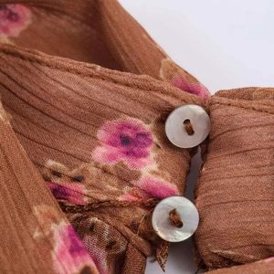 Floral print ribbed chiffon blouse featuring pearl buttons and a delicate brown base