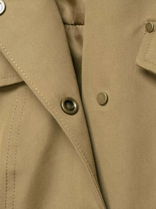 Close-up of khaki utility jacket showing durable twill fabric and vintage metal snaps
