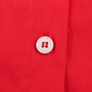 Classic red loose-fit shirt with a close-up of a white button and detailed stitching
