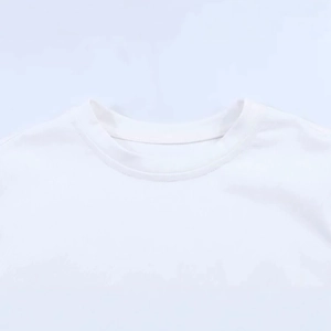 Close-up of white crew neck T-shirt neckline with delicate lace patchwork and stitching