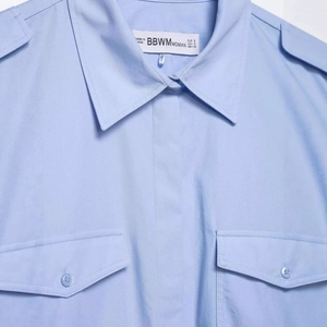 Chemisier femme bleu clair à épaulettes et poches poitrine au style utilitaire