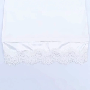 White long-sleeved T-shirt for women featuring delicate lace patchwork and silk-like hem details