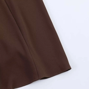 Detailed close-up showing the professional hem stitching on a dark brown sleeveless dress