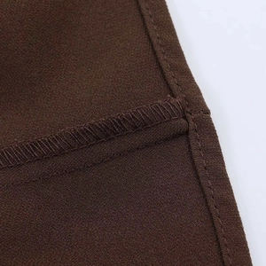 Detailed macro view of high-quality double-needle stitching and seaming on brown fabric