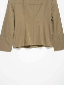 Close-up of khaki twill work jacket back hem and sleeve cuff with refined stitching