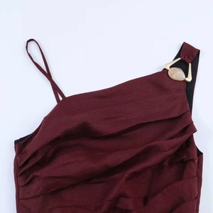 Asymmetric burgundy pleated midi dress with gold triangular hardware and resin detail