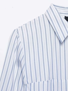 Macro close-up detail of the collar and shoulder area of a blue striped shirt dress