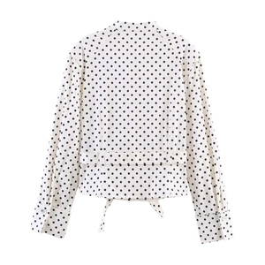 Detailed back view of vintage polka dot shirt with waist buttons and tie-knot hem