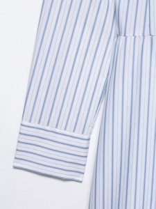Detailed view of the striped dress sleeve cuff with contrast horizontal patterns