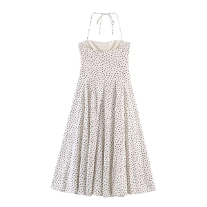 White halter neck midi dress with black polka dots featuring open back and tie detail