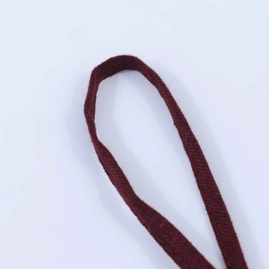 Macro close-up of dark red woven fabric texture showing a detailed herringbone pattern