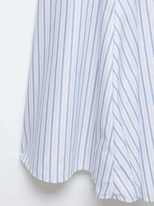 Detailed stitching and texture on the hem of a blue and white striped midi dress