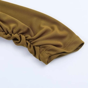 Detailed macro shot of olive green knit dress sleeve with ruched pleats and fine texture