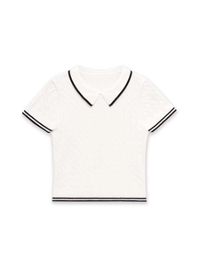 Detail of cable-knit texture and black contrast trim on white short-sleeve polo shirt