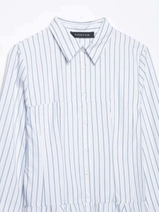 Detail of blue and white striped shirt collar with brand label and button down front