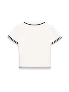 Close-up of the cable-knit texture and contrasting striped hem of a white knitted top