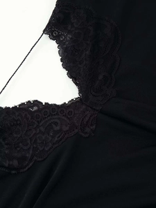 Close-up of intricate black lace trim and slender shoulder strap on summer dress
