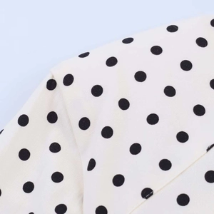 Detail of white vintage polka dot fabric with crisp texture and neat stitching seams