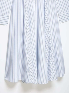 Detailed view of blue and white striped shirt dress with button placket and refined cuffs