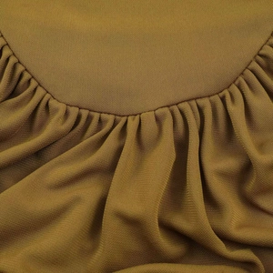 Macro view of textured brown fabric with detailed stitching and soft drape pleats