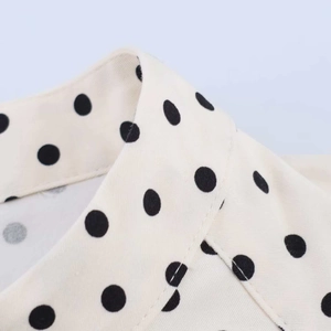 Close-up of vintage polka dot collar and high-quality fabric texture on this summer top