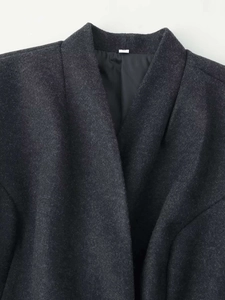 Detail view of charcoal gray wool coat collar showing textured fabric and smooth inner lining